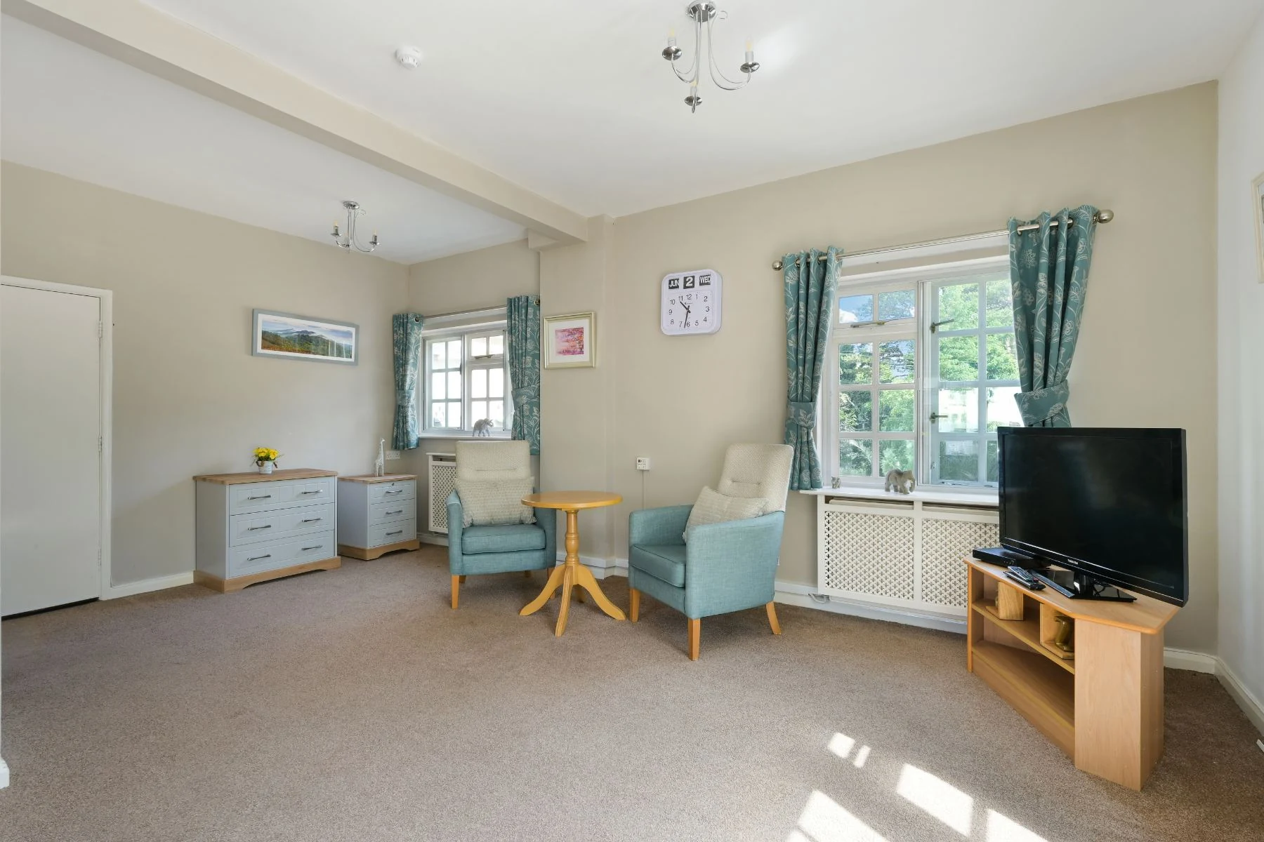 Bright room with armchairs and garden views